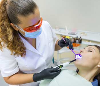 Dentist using Sedation dentistry for a lady patient